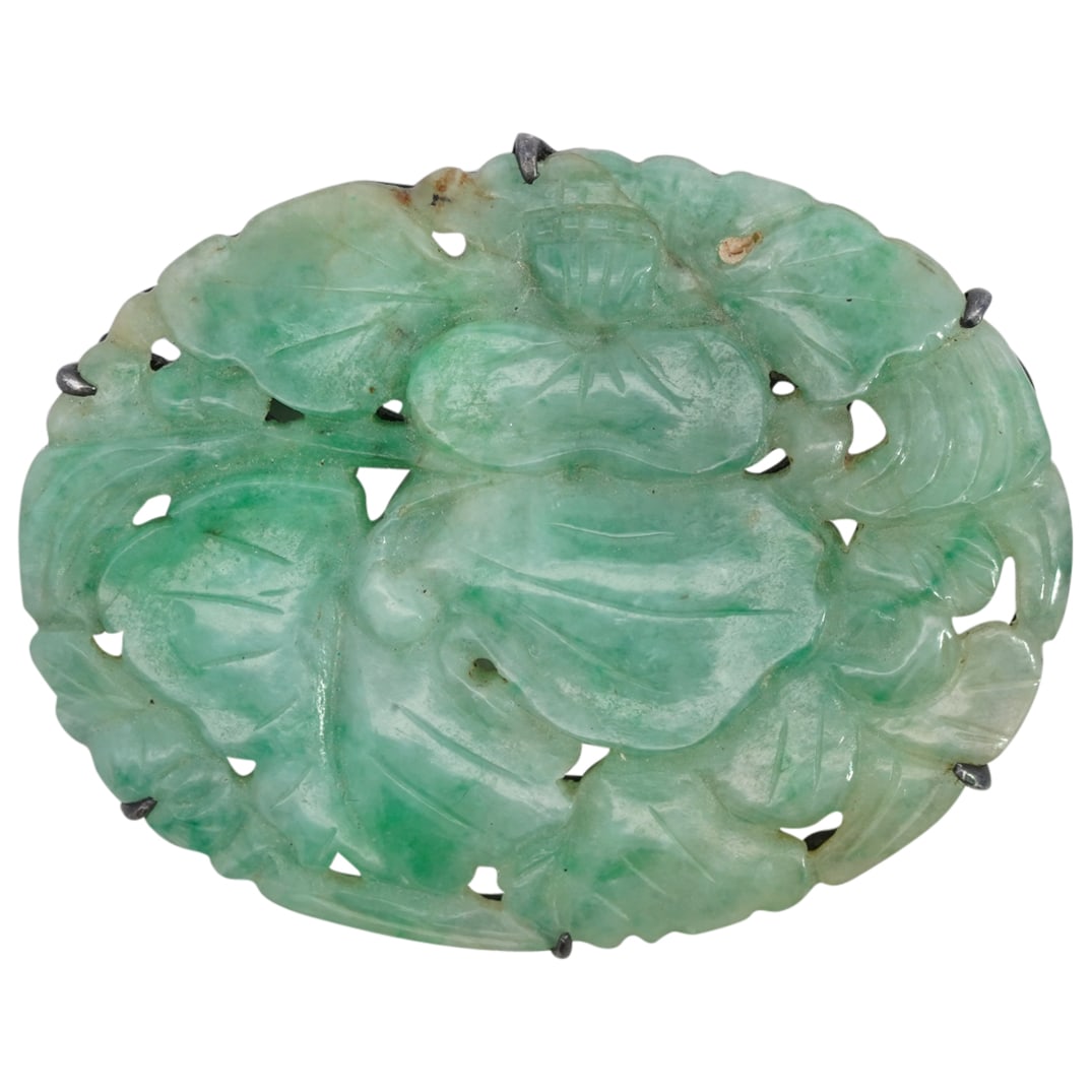 Chinese Carved Jadeite & Silver Brooch: DESCRIPTION: Chinese brooch featuring carved jadeite plaque decorated with lotus and foliage motifs placed within a silver mount. Unmarked. Total weight: 10 g CIRCA: 20th century or later ORIGIN: Chin