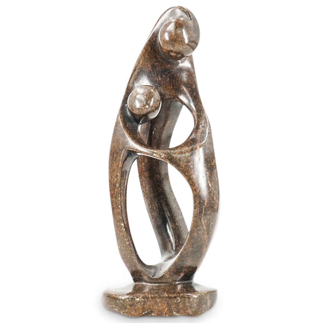 Abstract Soapstone Mother And Child: DESCRIPTION: Soapstone sculpture depicting an abstracted depiction of a mother cradling a child. CIRCA: 20th Century ORIGIN: Continental DIMENSIONS: H: 9" W: 2.75" L: 3.5" CONDITION: Minor scuffs and