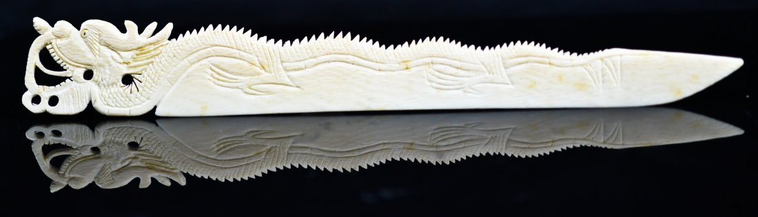Antique Chinese carved ivory letter opener of a drag: DESCRIPTION: Antique Chinese carved ivory letter opener of a dragon, excellent details on the dragon's back. Very sharp and in excellent condition. We will only ship ivory domestically in accordance w