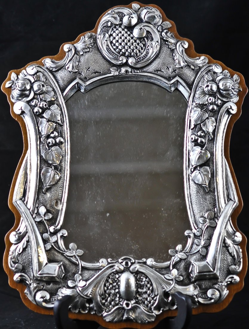 Silver Art Nouveau style hanging mirror. Stamped .9: DESCRIPTION: .950 silver Art Nouveau style hanging mirror with wood back. Fruit and floral design. Very heavy for it's size. Small hole in silver. Aged patina. Gorgeous CIRCA: 1960's-1980's MADE IN: G