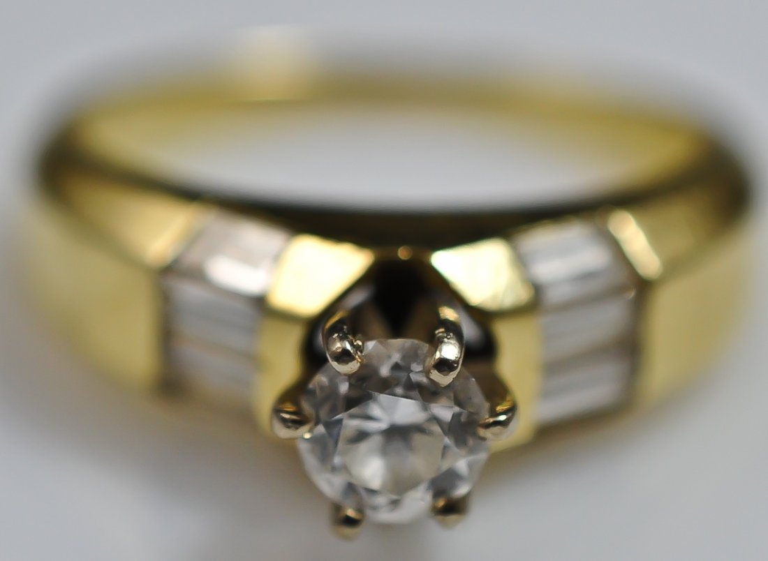 Ladies 14k yellow gold solitaire diamond ring 0.87t: DESCRIPTION: Ladies 14k yellow gold and diamond ring. Center stone is a 0.48ct modern cut natural diamond with open culet. G-H color. Great symmetry. VS1-VS2 clarity. Eight side baguettes with 0.40 tc