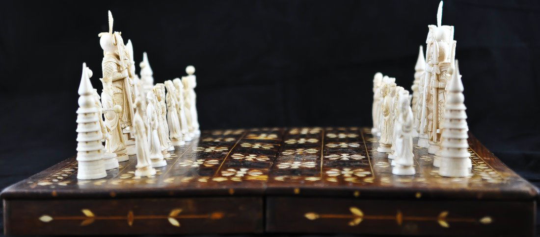 Antique Chinese hand carved ivory chess set: DESCRIPTION: Chinese hand carved ivory chess set. This is a complete set with all of the pieces accounted for. Each ivory piece is carefully hand crafted for the appropriate position on the board. The