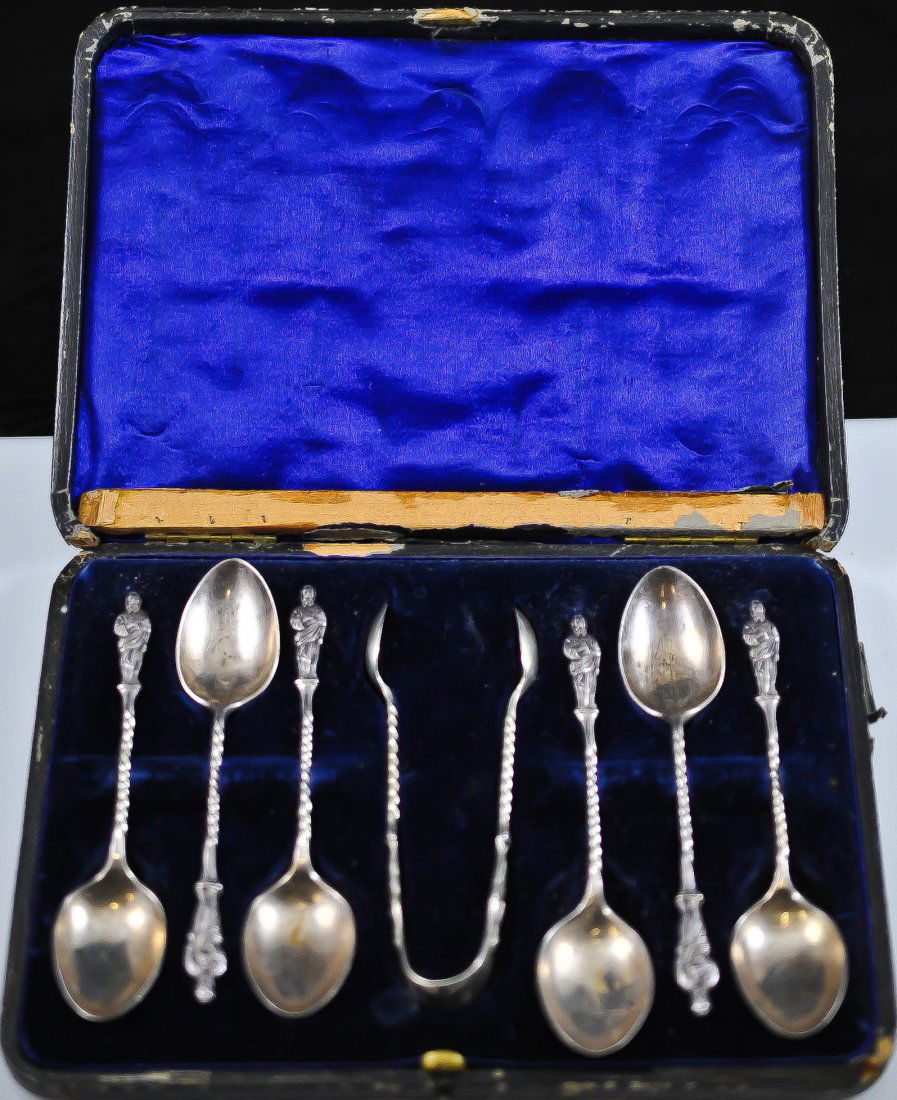 Set of seven English Sterling teaspoons in origina: DESCRIPTION: Seven English sterling teaspoons and one pair of sugar cube tongs. Each handle is of a robed and bearded man holding a book. The shaft has a twisted design. Each spoon is fully hallmarked