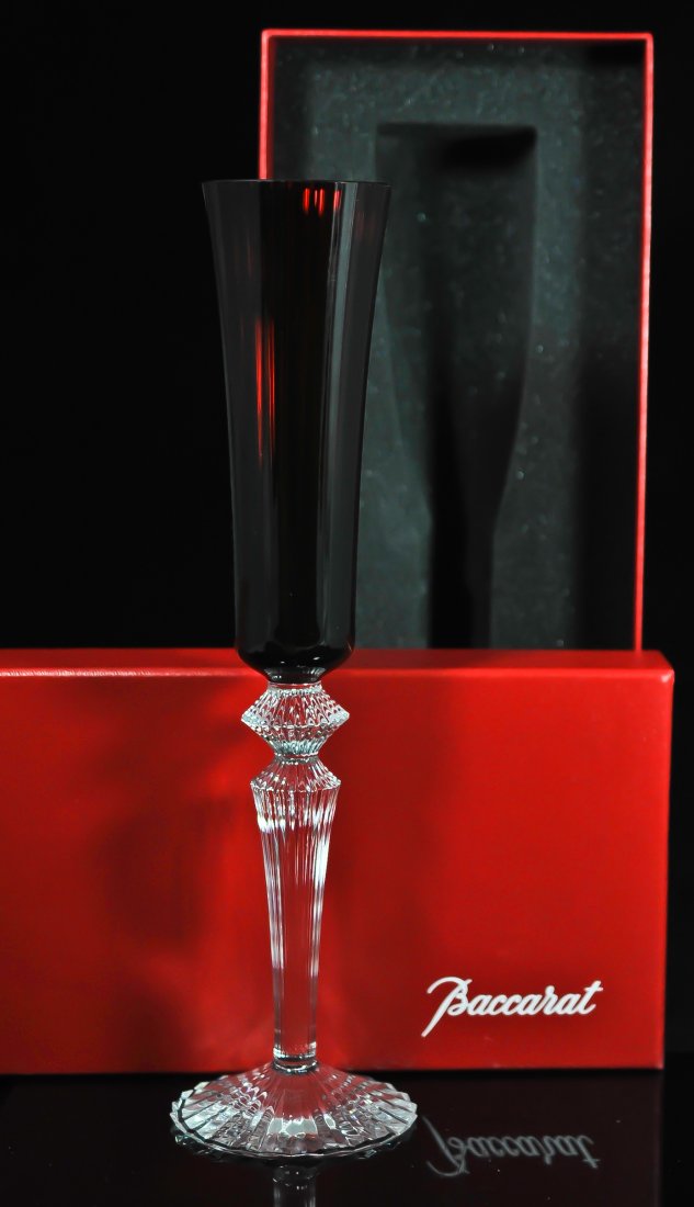 Baccarat crystal champagne flute by Mathias: DESCRIPTION: Limited edition Baccarat (ruby red) colored crystal champagne flute by famous designer Mathias, footed on a clear cut crystal steam. Never used and comes in original Baccarat box. Hallmar