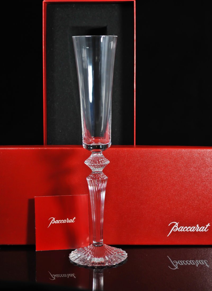 Baccarat crystal champagne flute by Mathias: DESCRIPTION: Limited edition Baccarat crystal clear champagne flute by famous designer Mathias, footed on a clear cut crystal steam. Never used and comes in original Baccarat box. Hallmarked underneat