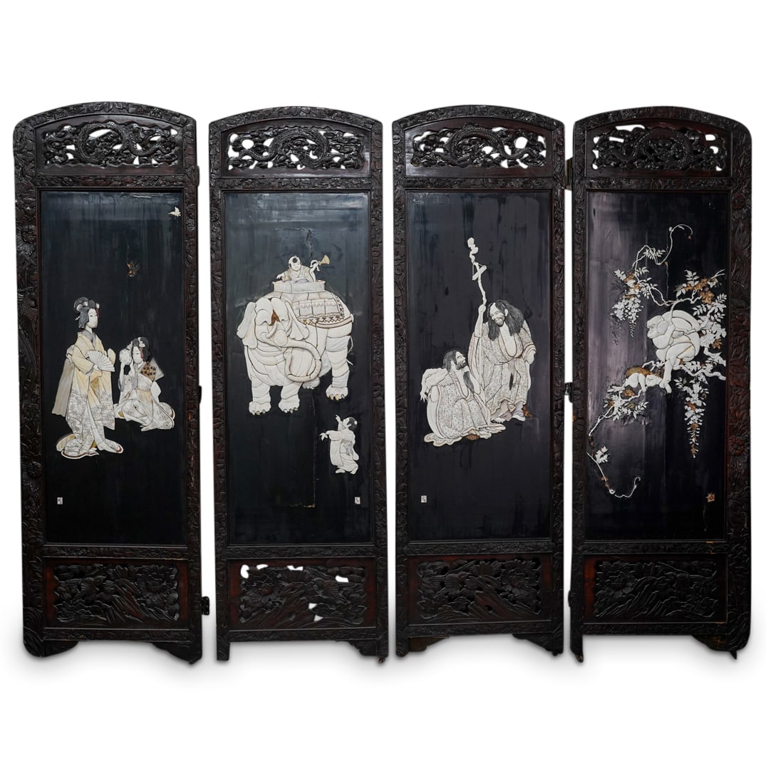 Antique Japanese Four-Panel Floor Screen: DESCRIPTION: Carved, ebonized wood screen from the late Meiji or early Taisho period featuring four panels, each featuring a pierced dragon crest at the top and sporting inlaid carved bone scenes on o