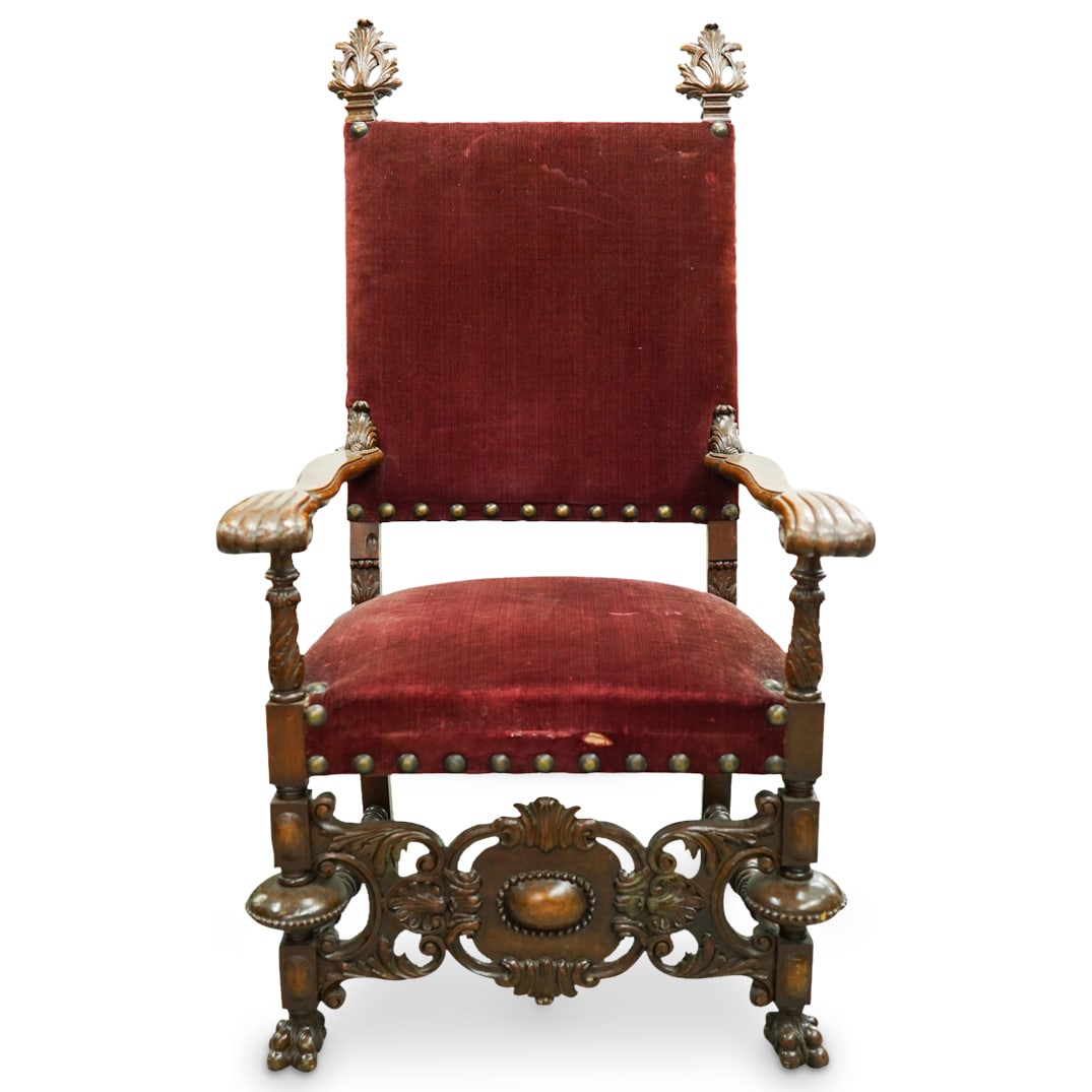Italian Renaissance Revival Throne Armchair: DESCRIPTION: Italian Renaissance revival throne armchair with dark carved wood frame with leaf and foliage ornate motifs, ornate carved reticulated stretcher, lion's paw feet, and red velvet upholster
