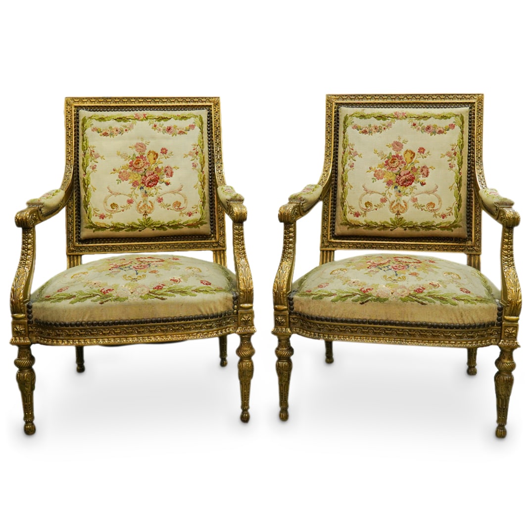 (2 Pc) Antique French Aubusson Fauteuil Upholstered Armchairs: DESCRIPTION: (2 Pc) Antique French pair of Aubusson fauteuil tapestry upholstered armchairs. Upholstered seat, back and arm rests with fabric embellished with a floral motif. Gilt wooden frame. CIRCA: