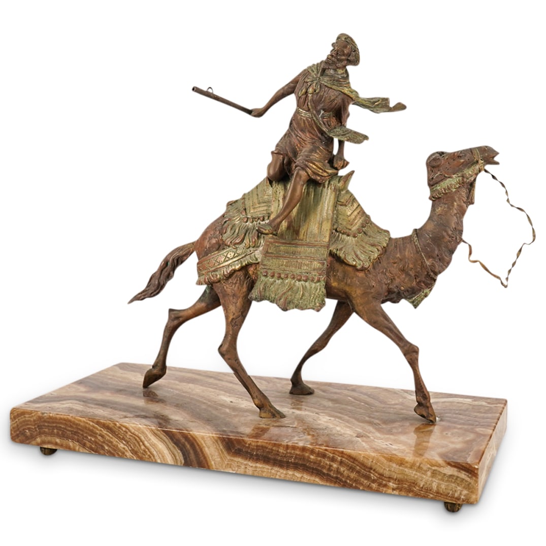 Orientalist figural Group of a Bedouin Soldier: DESCRIPTION: Orientalist figural group of a Bedouin soldier on a camel mounted on a light brown to tan variegated base. CIRCA: 20th century ORIGIN: Arabic DIMENSIONS: Bronze H: 11"11.5" W: D: 4" CONDI