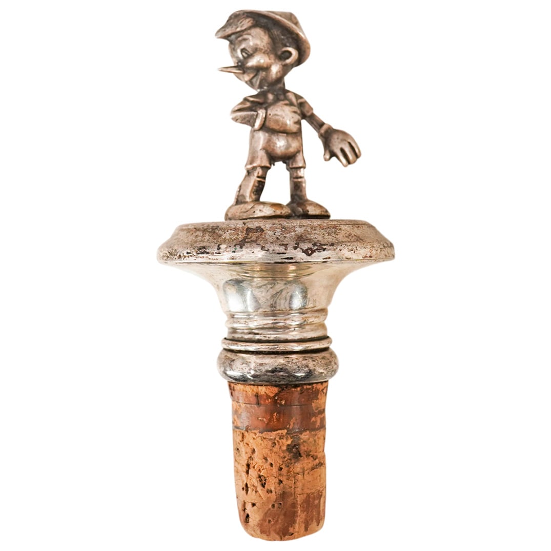 Sterling Silver Disney Pinocchio Wine Stopper: DESCRIPTION: Sterling silver Disney Pinocchio wine stopper. CIRCA: 20th Cent. ORIGIN: USA DIMENSIONS: H: 4.25" x Dia: 2" CONDITION: Slight tarnishing. Unless otherwise stated, all information provided