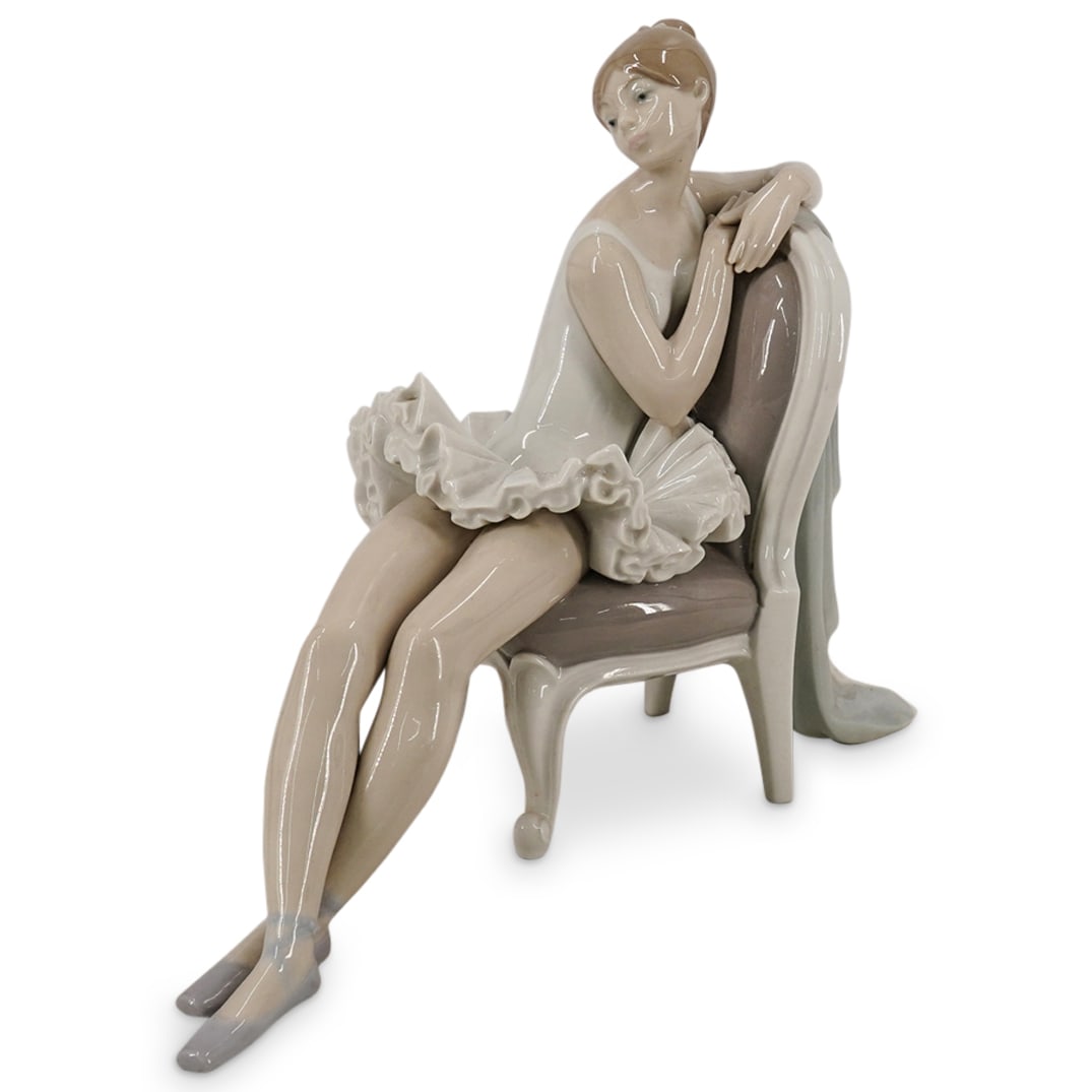 Lladro #4847 Ballerina Figurine: DESCRIPTION: Lladro #4847 Ballerina figurine sitting on a chair in high gloss porcelain. Marked "Lladro" Handmade In Spain". CIRCA: Late 20th, early 21st century ORIGIN: Spain DIMENSIONS: H: 10": W: 1