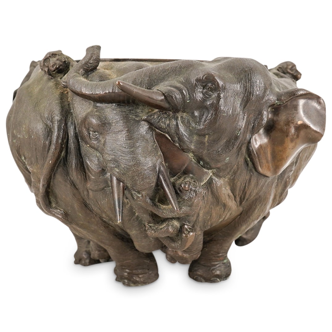 Antique Japanese Meiji Bronze Elephant And Monkey Jardinier: DESCRIPTION: Antique Meiji bronze jardiniere crafted with a continuous series of elephants and monkeys in high relief around its body, the feet of the elephants forming the feet of the jardinier. Mark