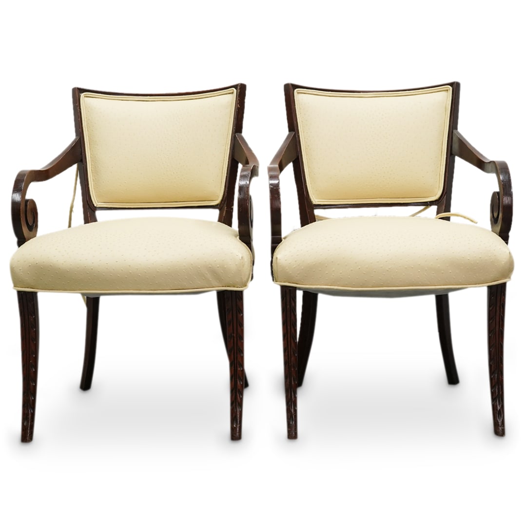 Pair Of Italian Carved Wood Ostrich Skin Armchairs: DESCRIPTION: Two matching carved wood chairs, each featuring ostrich skin upholstery and sporting foliage reliefs on front of legs. CIRCA: Early to mid-20th Century ORIGIN: Italy DIMENSIONS: H: 33.25"