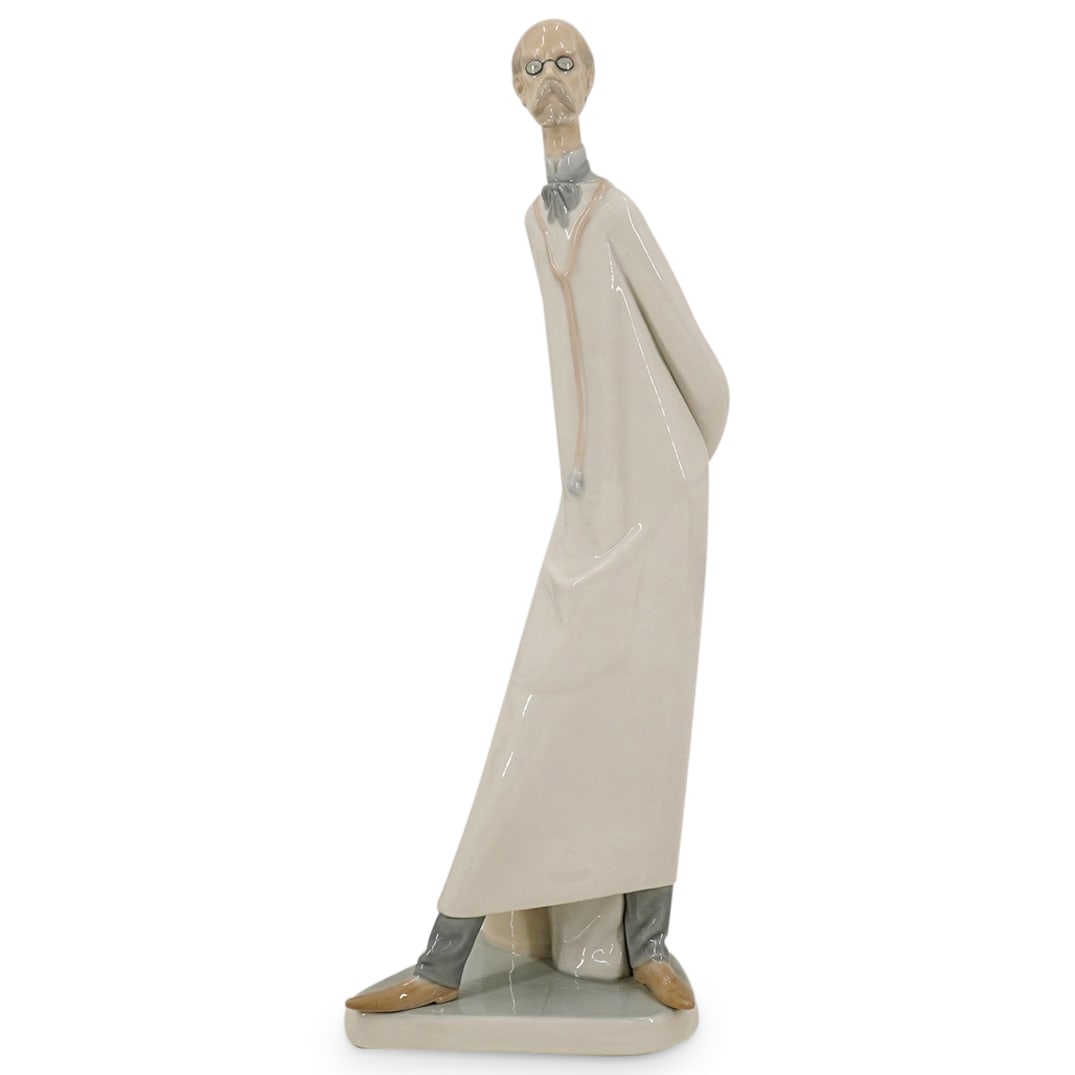 Lladro Glazed Porcelain "Doctor" Figurine: DESCRIPTION: Lladro Glazed Porcelain "Doctor" Figurine . Depicts a doctor with his hands behind his back. Marked with Lladro hallmark. CIRCA: 20th Century ORIGIN: Spain DIMENSIONS: H: 14" CONDITION: G