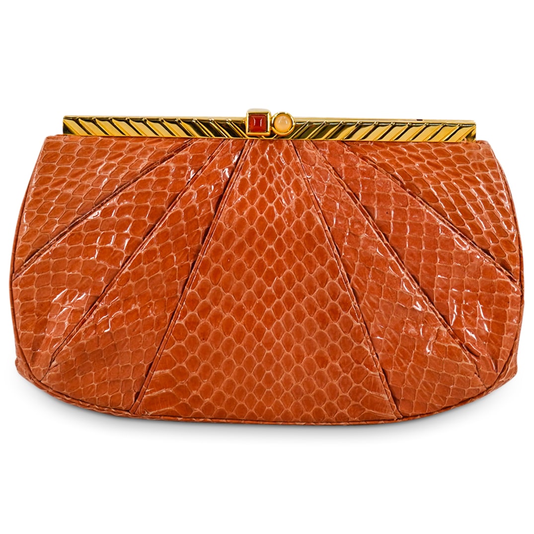 Vintage Judith Leiber Peach-Coral Snakeskin Leather Clutch: DESCRIPTION: Vintage Judith Leiber clutch featuring a peach-coral snakeskin leather exterior with gold-tone hardware, gilt metal shoulder strap and gilt closure clasp with cabochons. Branded "Judith L