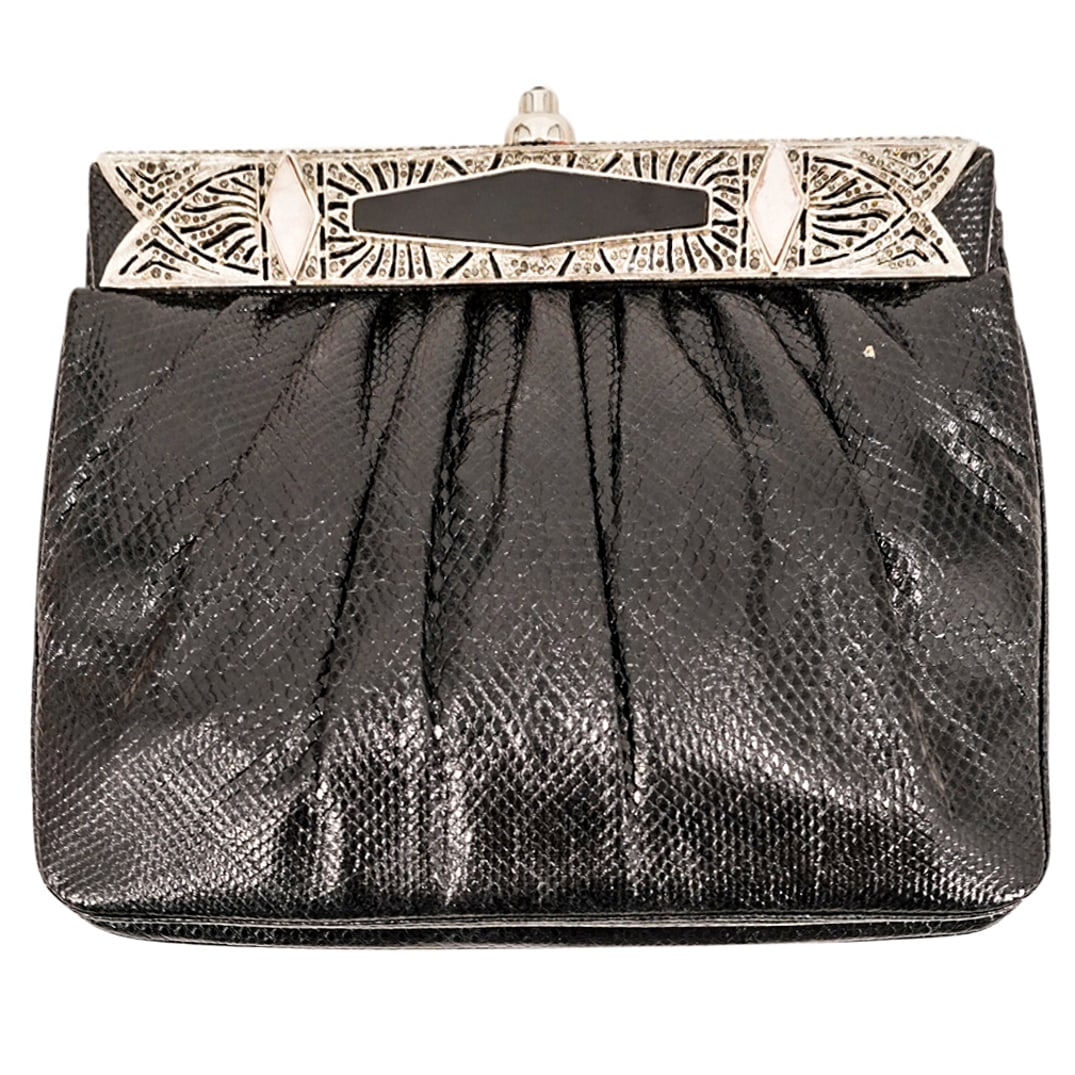 Vintage Judith Leiber Black Snakeskin Leather Clutch: DESCRIPTION: Vintage Judith Leiber clutch featuring a black snakeskin leather exterior with silver-tone hardware, silver-tone metal shoulder strap and closure push clasp with Art Deco style applied em