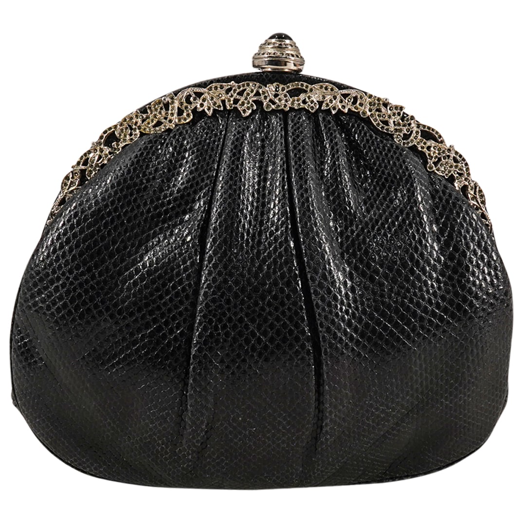 Vintage Judith Leiber Black Snakeskin Leather Clutch: DESCRIPTION: Vintage Judith Leiber clutch with semi circular rounded form, featuring a black snakeskin leather exterior with silver-tone hardware with ornate floral motif, silver-tone metal shoulder s