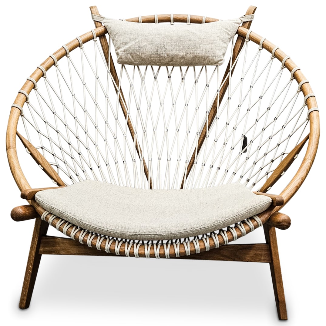 After Hans Wegner Circle Net Lounge Chair Cream: DESCRIPTION: After Hans Wegner circle net lounge chair with large wooden frame and cream hued upholstery. CIRCA: 20th Century ORIGIN: USA DIMENSIONS: W: 45" D: 37 1/4" H: 38" CONDITION: Great, pre-own