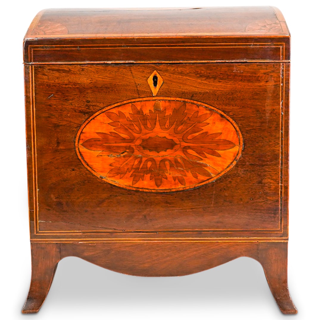 Antique George III Marquetry Wine Cellarette: DESCRIPTION: Carved Wood wine cellarette featuring an arched lid concealing an interior with nine slots for wine bottles. Lid is fitted with a locking mechanism and decorated with marquetry medallions