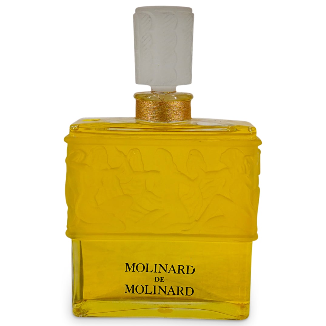 Factice Molinard de Molinard Lalique Design Display Perfume Bottle: DESCRIPTION: Molinard de Molinard Lalique Design Display Factice Perfume Bottle. Designed bottle with frosted nude women in a band around. CIRCA: 20th Century ORIGIN: France DIMENSIONS: H: 12 1/4" W: 