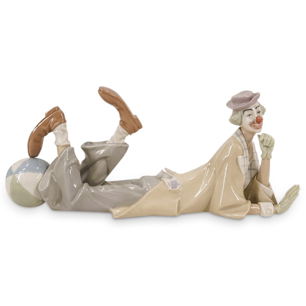 Lladro "Payaso Acostado" Porcelain Figure: DESCRIPTION: Lladro "Payaso Acostado" porcelain figure depicting a clown. Marked on underside. Includes box. CIRCA: Late 20th - early 21st century ORIGIN: Spanish DIMENSIONS: (Figure) H: 6.25" W: 4.75