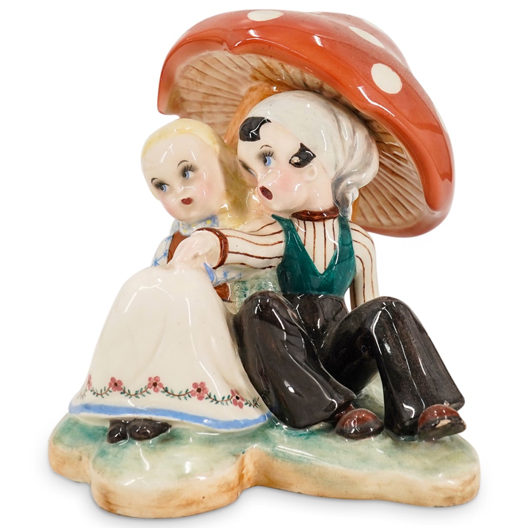 After Tiziano Galli Porcelain Children Under Mushroom: DESCRIPTION: Porcelain sculpture depicting a boy wooing a girl - both in traditional central European garb - beneath an amanita mushroom. Bears Galli's signature and "ITALY" on verso beneath mushroom.