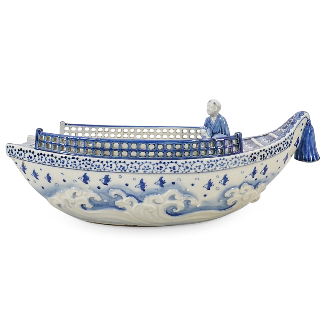 Japanese Hirado Porcelain Blue and White Boat: DESCRIPTION: Japanese Hirado Porcelain Blue and White Boat. A porcelain boat with a seated figure of a man at the bow, the interior is painted with three small swimming small, form the Imperial kilns 