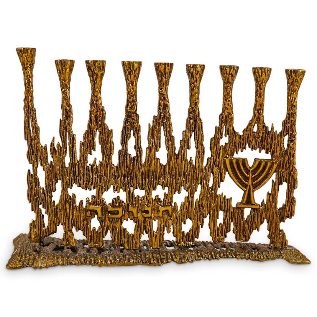 Wainberg Brutalist Menorah: DESCRIPTION: Wainberg brutalist metal menorah featuring Hebrew characters and gold-toned coloration. Marked with "Wainberg" and "Made in Israel" on underside. CIRCA: Late 20th - early 21st century ORI
