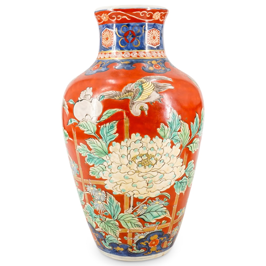 19th Century Japanese Imari Porcelain Vase: DESCRIPTION: Antique Imari porcelain vase fashioned in a shouldered form featuring intricately crafted floral, bird, and foliage motifs against a coral tone background sporting blue borders and gilt a