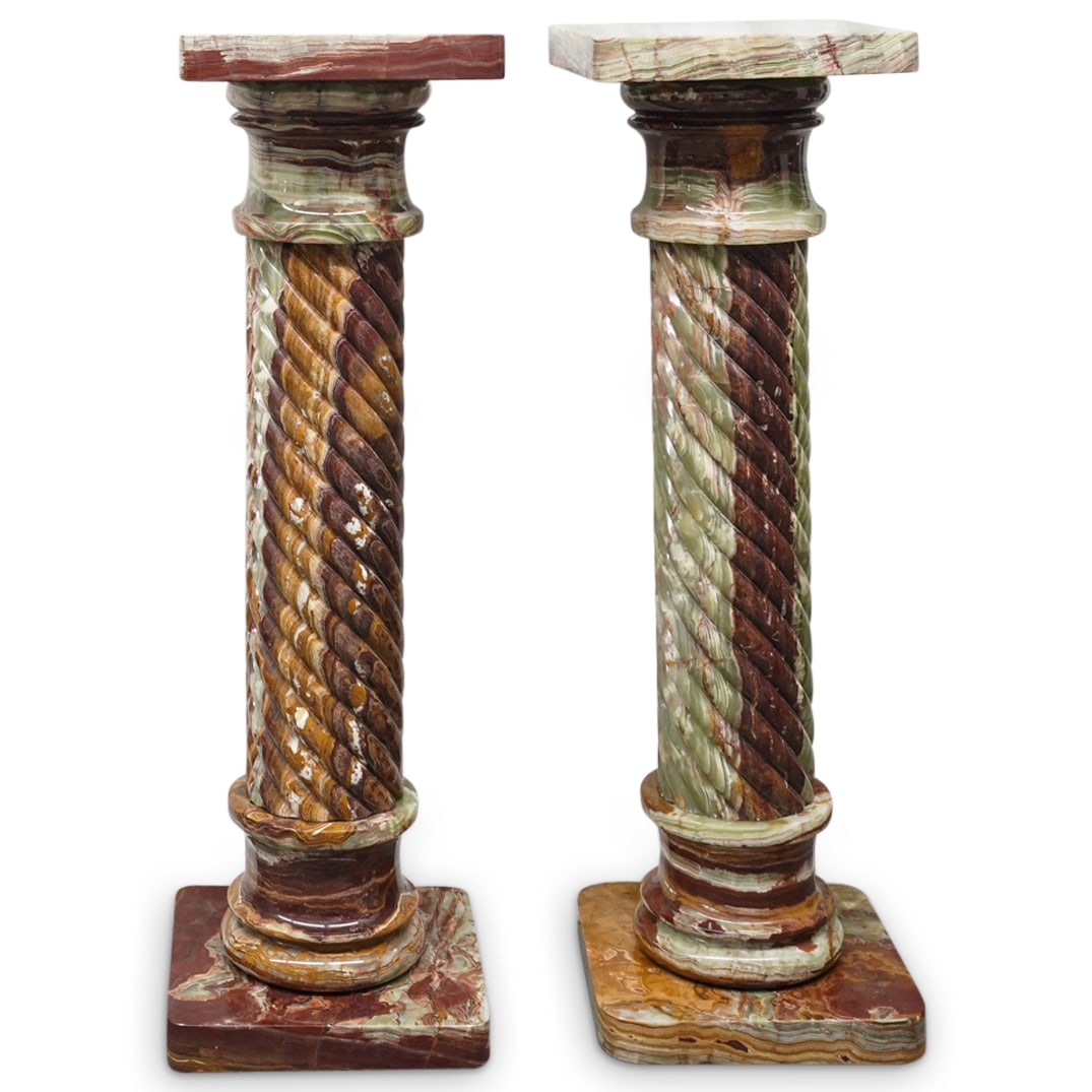 Pair Of Italian Onyx Twisted Column Pedestals: DESCRIPTION: Two matching pedestals, each featuring a twisted column, eye-catching marbling, and a rounded platform and foot. CIRCA: Early-Mid 20th Cent. ORIGIN: Italy DIMENSIONS: H: 48" W: 15.5" L: 1