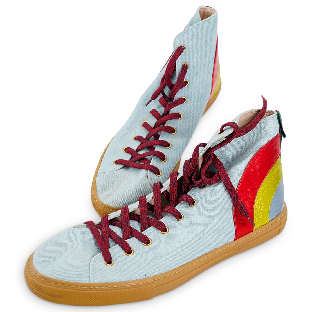 Gucci Men's Blue Denim Rainbow Sneakers: DESCRIPTION: Gucci Men's high cut blue denim sneakers with metallic hued leather rainbow accents. Made of fabric, with leather lining and rubber sole. Numbered 450887. Size 12. Provenance: From a prom