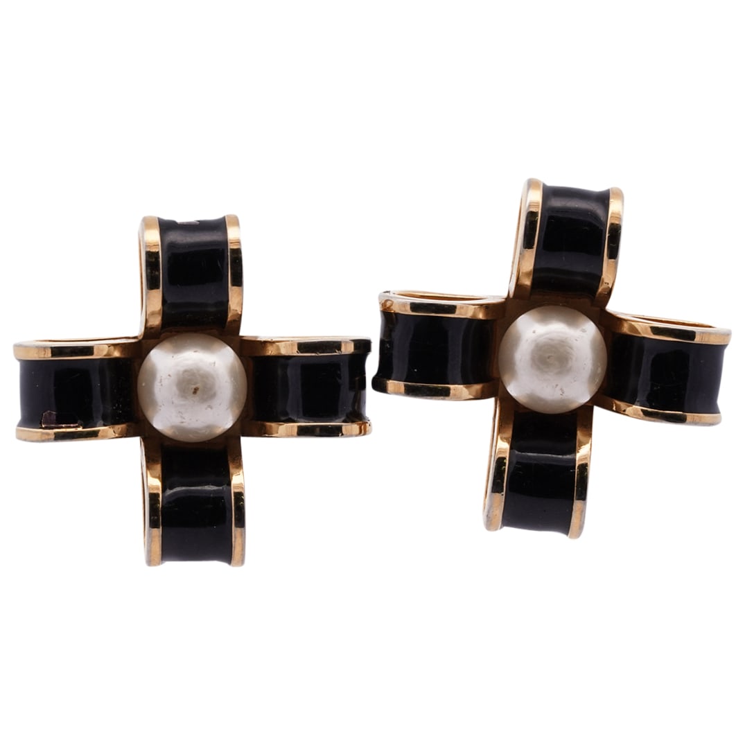 Pair Of Rare Chanel Black Enamel And Gil Ribbon Earrings: DESCRIPTION: Pair of Chanel earrings, each fashioned as a black ribbon with gilt accenting and a large faux pearl at its center. Hallmarked on verso. CIRCA: 1980s ORIGIN: France DIMENSIONS: H: 1.5" W: