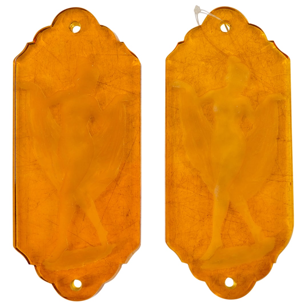 Pair Of Bohemian Glass Neo Classical Embossed Figural Door Pushers: DESCRIPTION: Two matching door pushers, each composed of orange Bohemian glass and embossed with the figure of a woman posing with a mantle. CIRCA: Early to mid-20th Century ORIGIN: Czechoslovakia DIM