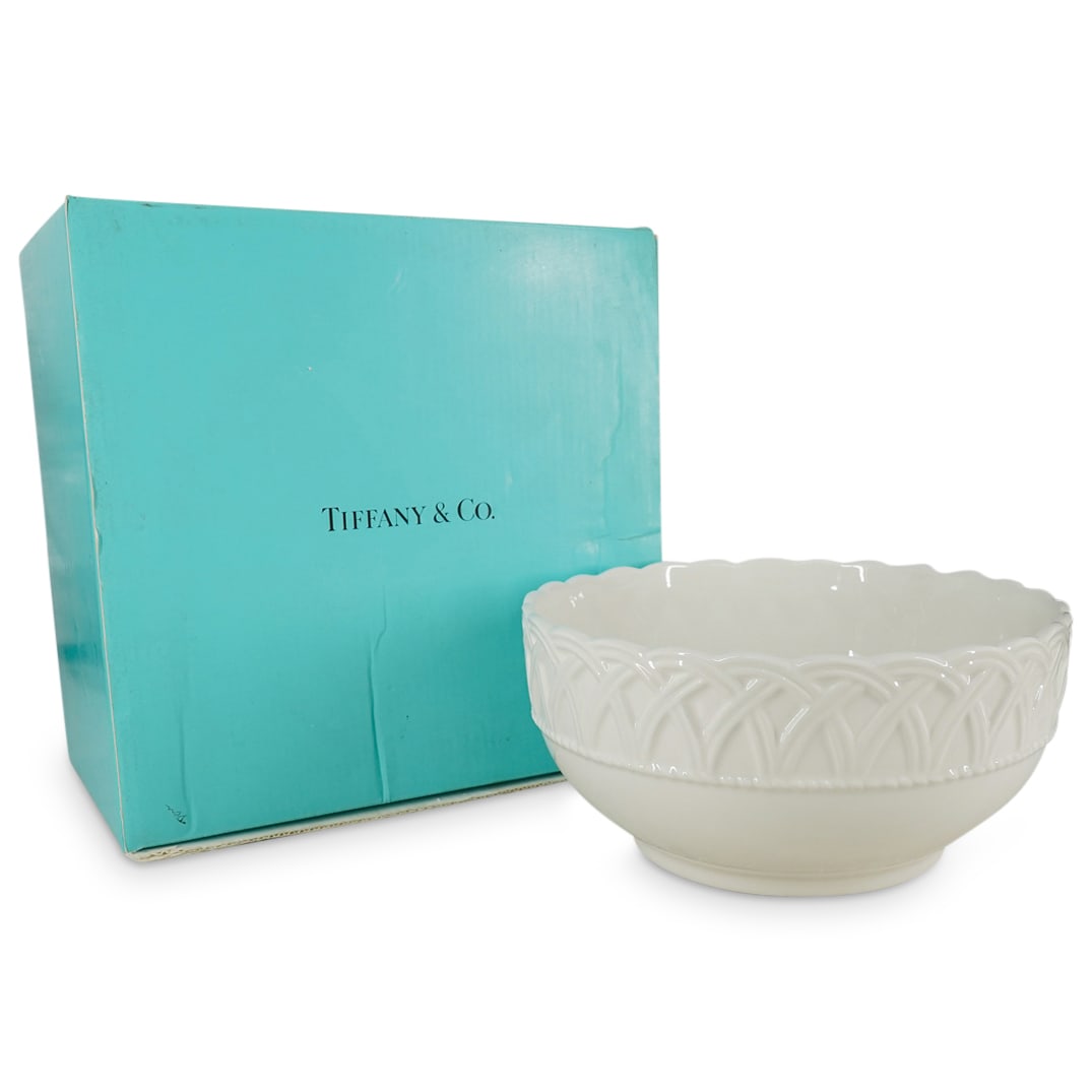 Tiffany White Porcelain Bowl: DESCRIPTION: Tiffany white porcelain bowl with a woven basket motif and a top scalloped rim, marked on the bottom "Made in Italy Exclusively for Tiffany & Co.", with original box. CIRCA: Early 21st ce