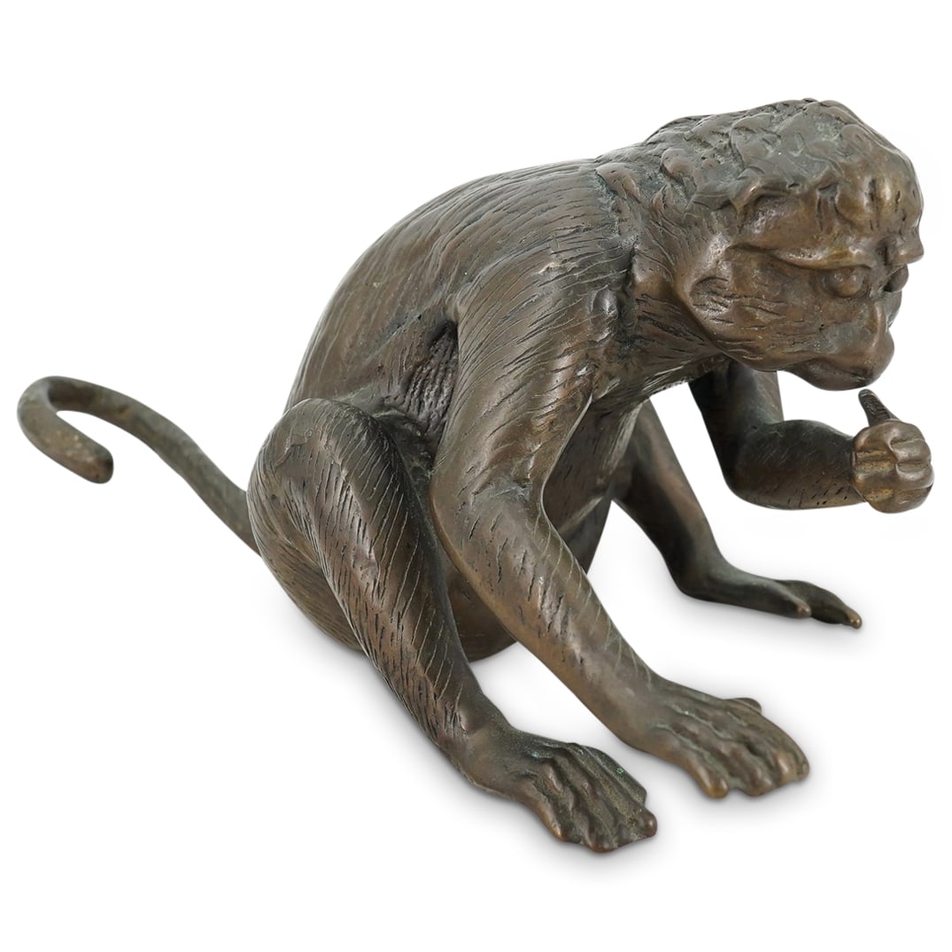 Vintage Bronze Long-Tailed Seated Macaque Monkey Sculpture: DESCRIPTION: Vintage bronze animal sculpture depicting a long-tailed seated macaque monkey, designed with etched texture depicting naturalistic details, with a detailed body surface and well-defined f