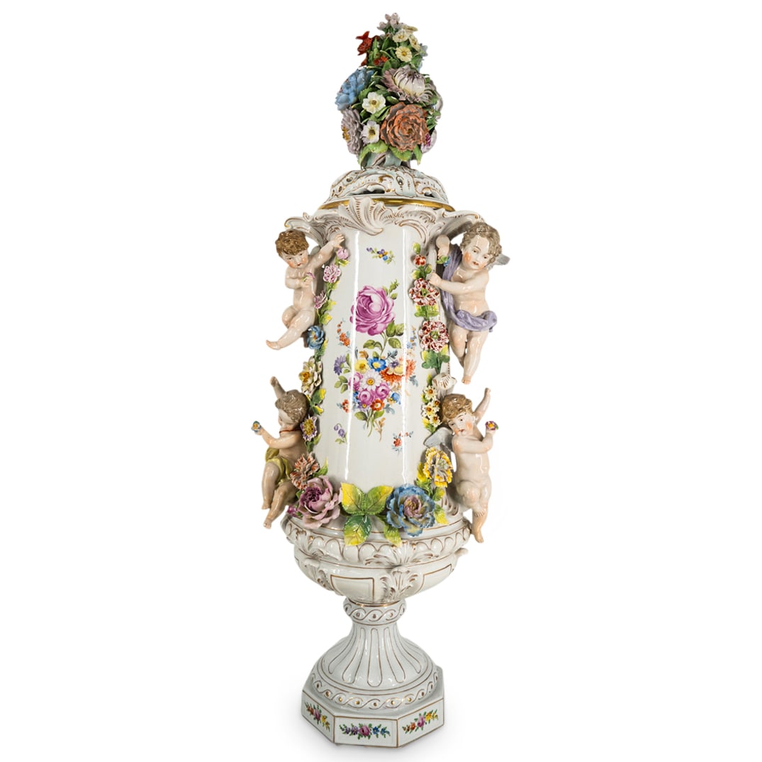 Fine Antique Meissen Floral Porcelain Urn: DESCRIPTION: Fine antique hand painted Meissen porcelain urn featuring putti, finely detailed flowers and finial in the form of a cluster of flowers. Completed with gilt accents and marked on undersid