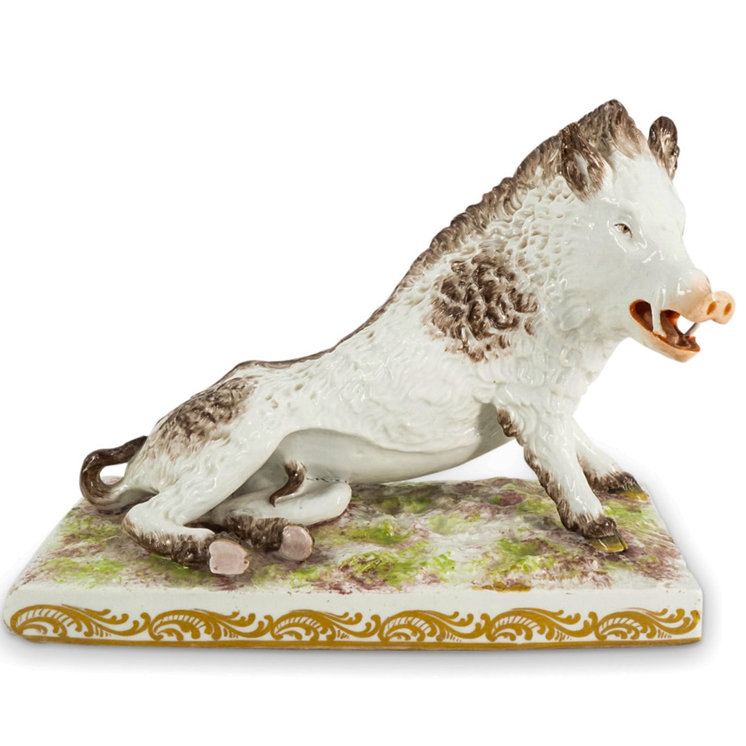 19th Cent. Meissen Porcelain Wild Boar: DESCRIPTION: 19th Century Meissen porcelain wild boar with naturalistic form and hand painted details, posed reclined on rectangular, terrain textured base. Underglaze blue crossed sword mark. CIRCA: