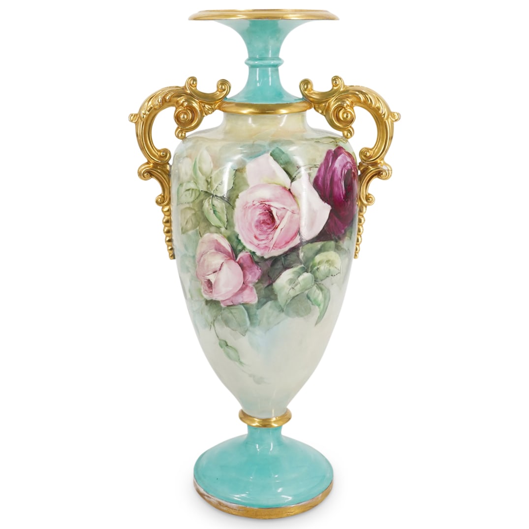 Antique Belleek Painted Porcelain Urn: DESCRIPTION: An Antique Belleek porcelain urn decorated along the body with hand painted roses over a teal ground color. Flanked along the sides with ornate gilt handles, marked along the underside "B