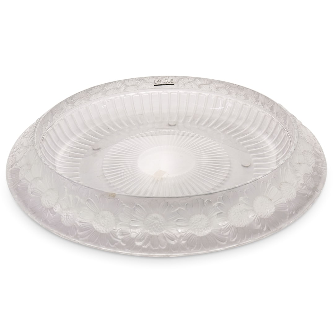 Lalique "Marguerite" Crystal Centerpiece Bowl: DESCRIPTION: Lalique "Marguerite" crystal centerpiece bowl featuring sunflower designs around the lip and marked "LALIQUE FRANCE" on underside. Stickers: "LALIQUE FRANCE" and "MADE IN FRANCE". CIRCA: 