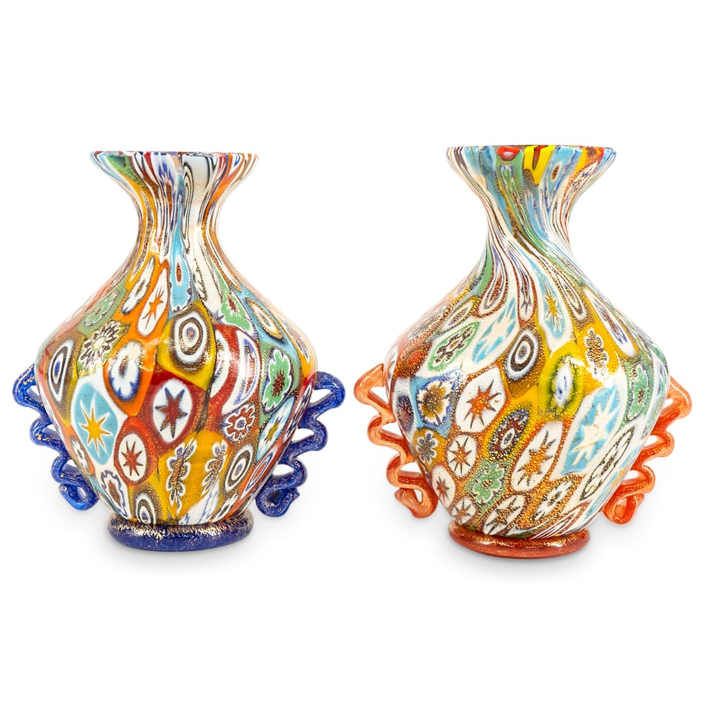 Pair of Gambaro & Poggi Millefiori Murano Vases: DESCRIPTION: A pair of Gambaro & Poggi Murano glass vases decorated along the body with millefiori designs, flanked on either side with scrolling handles and completed with gilt accents. One with "vet