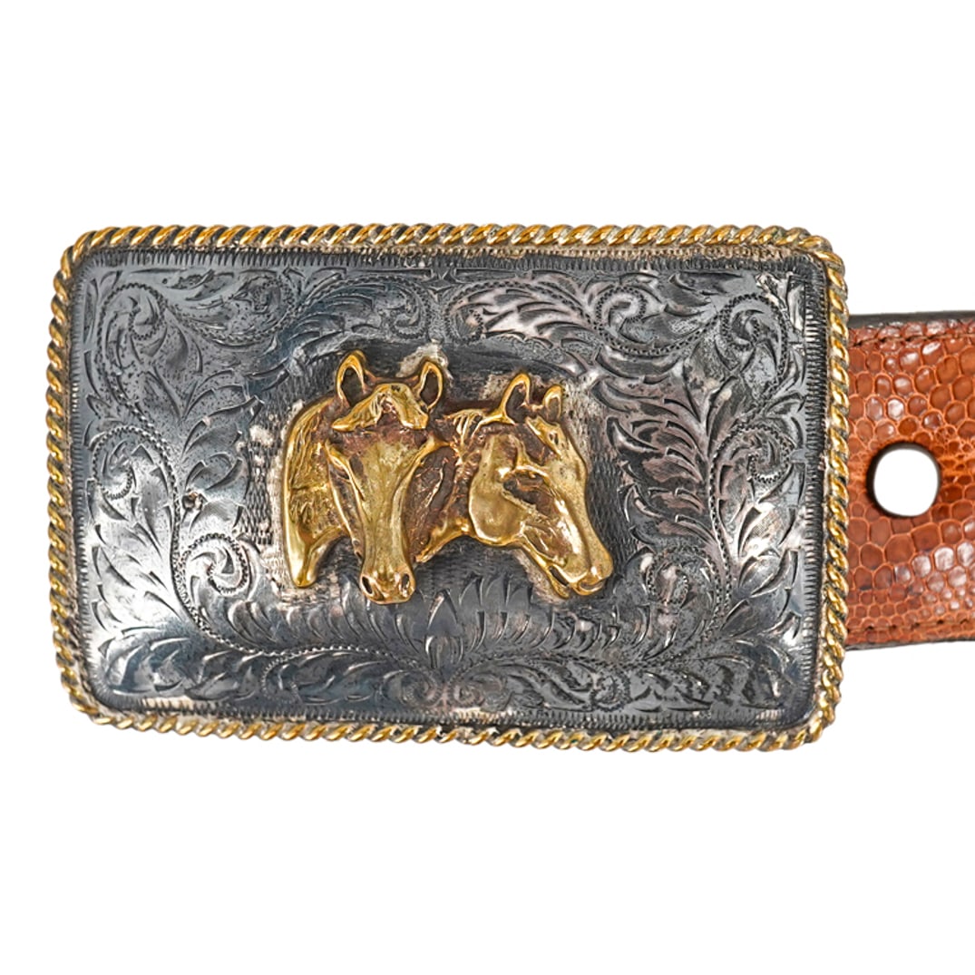 Ralph Lauren Polo Sterling Overlay Buckle W/ Leather Belt: DESCRIPTION: Leather belt featuring a Polo sterling overlay buckle by Ralph Lauren decorated with gilt overlay horse designs and braided border. Finished with a sterling sterling silver tip. CIRCA: 20