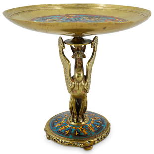 Ferdinand Barbedienne Champleve Griffin Compote: DESCRIPTION: Champleve compote featuring a gryphon form stem and sporting polychrome floral and foliage enamel patterns around base and in well of bowl. CIRCA: 19th Century ORIGIN: France DIMENSIONS: