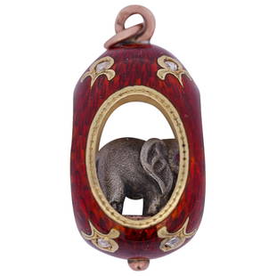 Faberge 14k Gold, Silver and Guilloche Elephant Pendant: DESCRIPTION: A Faberge pendant comprised of 14k yellow gold foundation decorated with deep red guilloche enamel with diamonds insets. The pendant frame encases a silver elephant with ruby inset eyes.