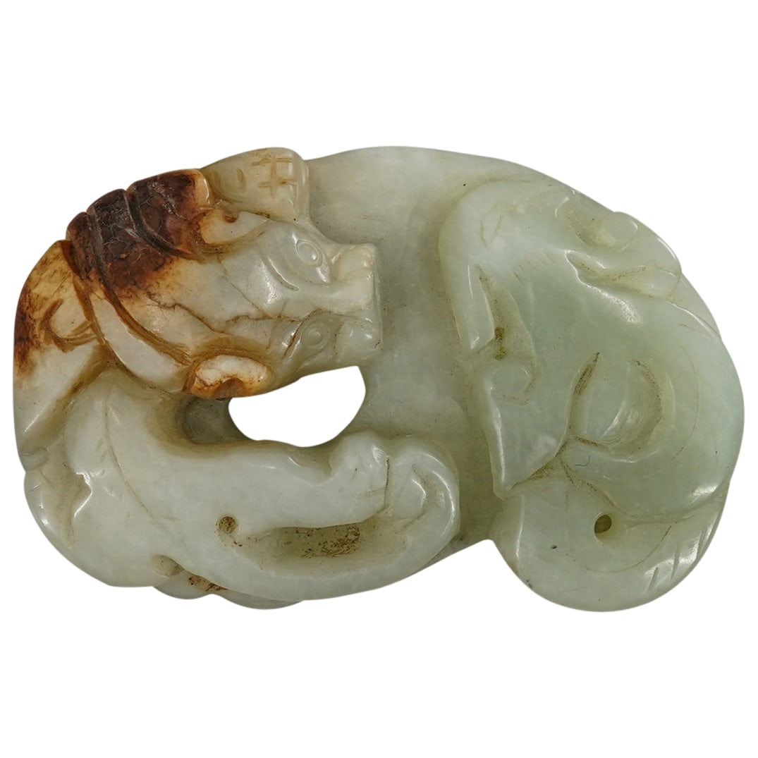 Chinese Jade carved pendant: DESCRIPTION: Chinese jade carved pendant figurine of a curled-up ox, stone color going from green to russet brown. CIRCA: 20th century. ORIGIN: China DIMENSIONS: H: 3.25" W: 2" D: .5" CONDITION: Greta