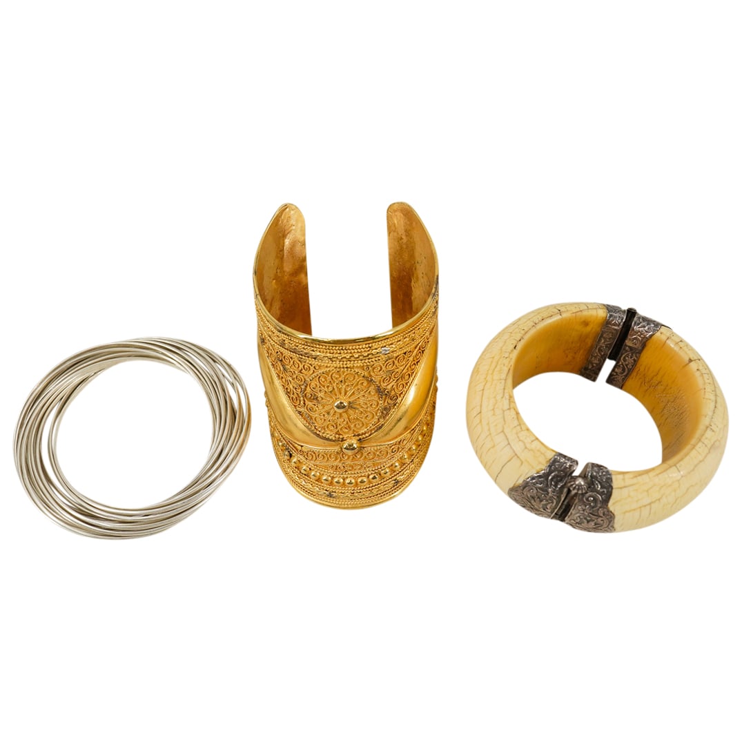 (3 Pc) Silver, Bone, And Gilt Jewelry Bracelets: DESCRIPTION: Three bracelets: one gilt metal Byzantine revival style cuff bracelet, one carved bone cuff bracelet with silver clasps, and one silver multi bangle bracelet from India with 21 intertwine