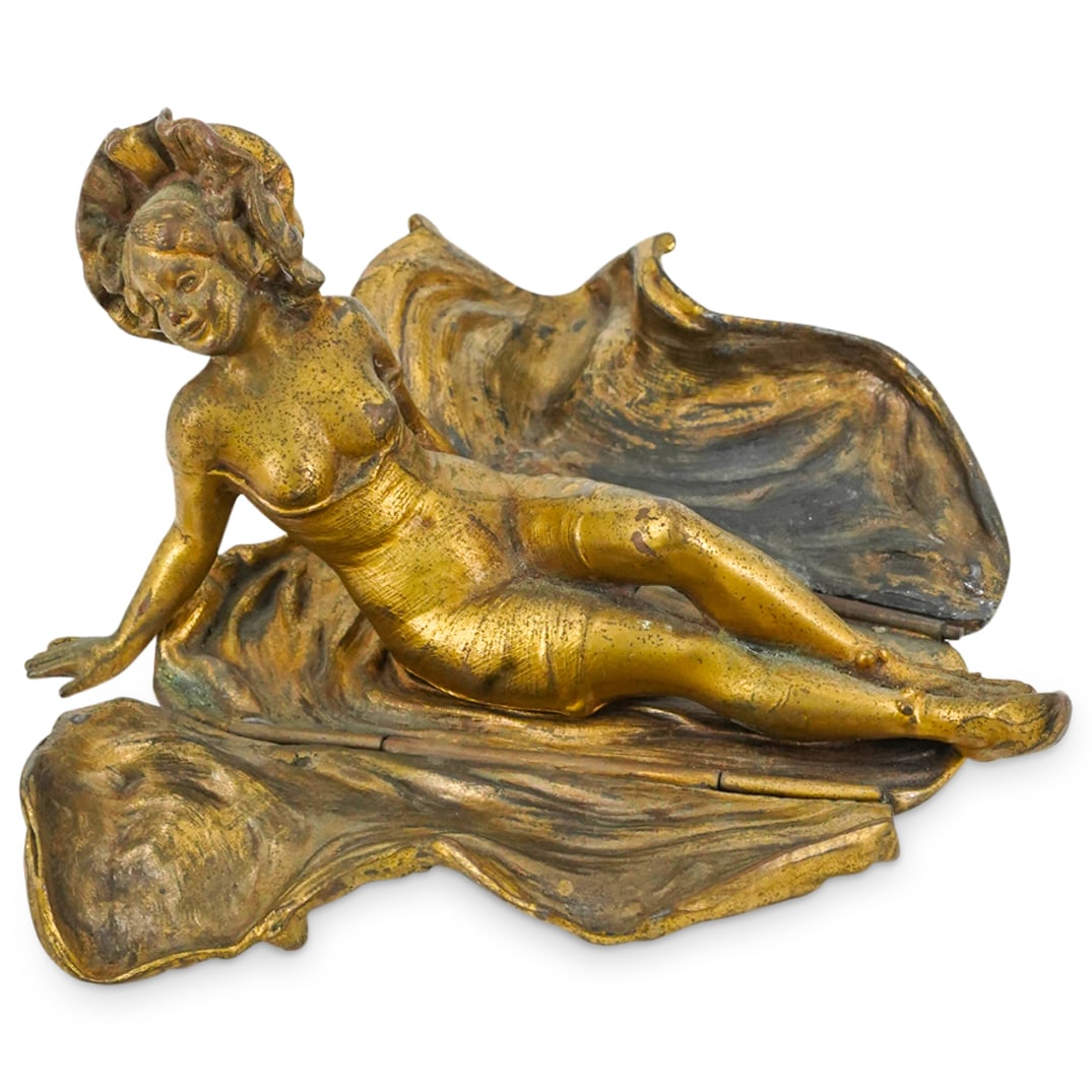 Antique Jennings Brothers Mixed Metal Erotic Woman: DESCRIPTION: Mixed metal erotic sculpture by Jennings Brothers depicting a woman wearing a bonnet and reclining while wrapped in hinged sheets which open to reveal scanty undergarments. Hallmarked on