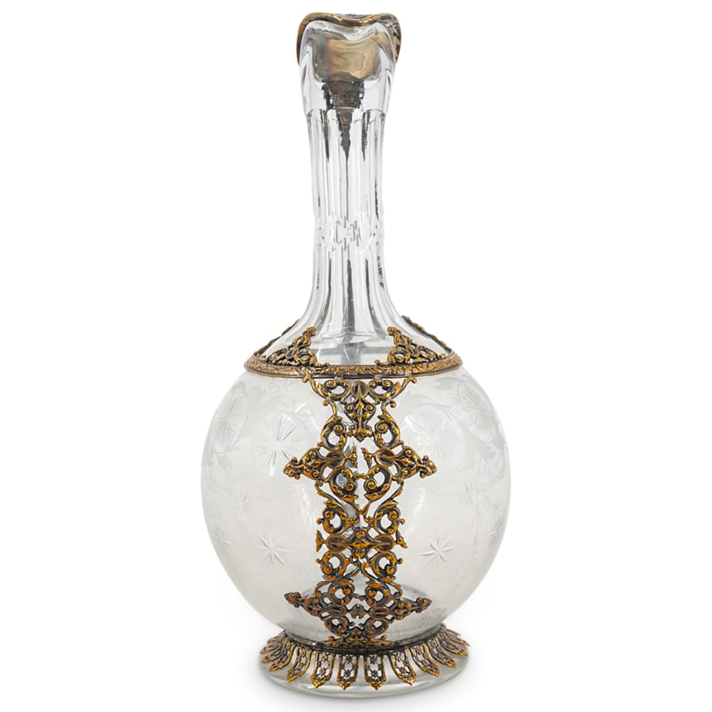 Antique French Glass And Metal Ewer: DESCRIPTION: Glass ewer decorated on its side with cut starbursts and frosted foliage and adorned with a gilt, mixed metal overlay around its foot and shoulder extending into a handle and hinged lid a
