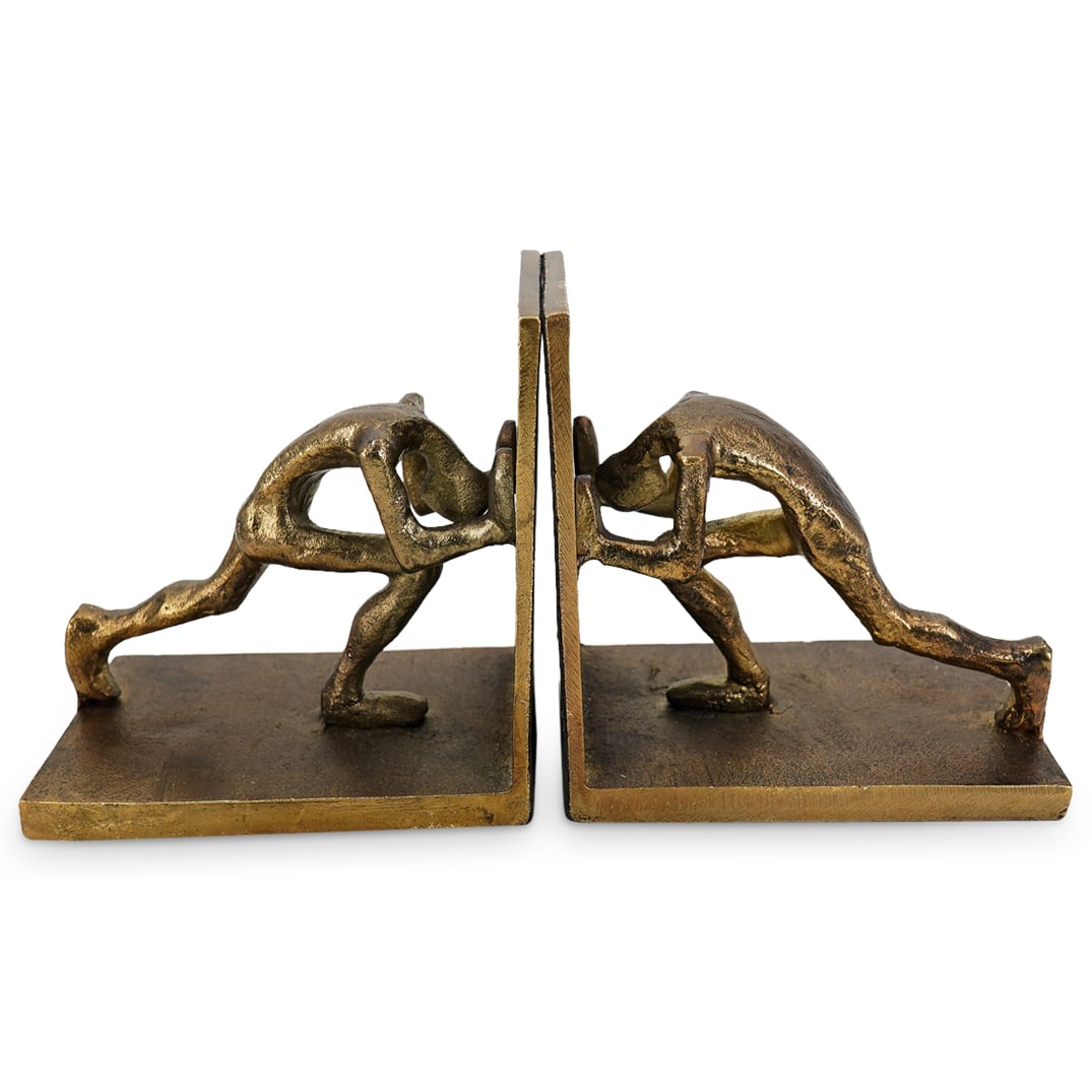 (2 Pc) Gilt Mixed Metal Figural Bookends: DESCRIPTION: (2 Pc) Gilt mixed metal figural pair of bookends depicting a male nude figure supporting the wall. With an antiqued gold patina finish. CIRCA: 20th Century ORIGIN: Continental DIMENSIONS: