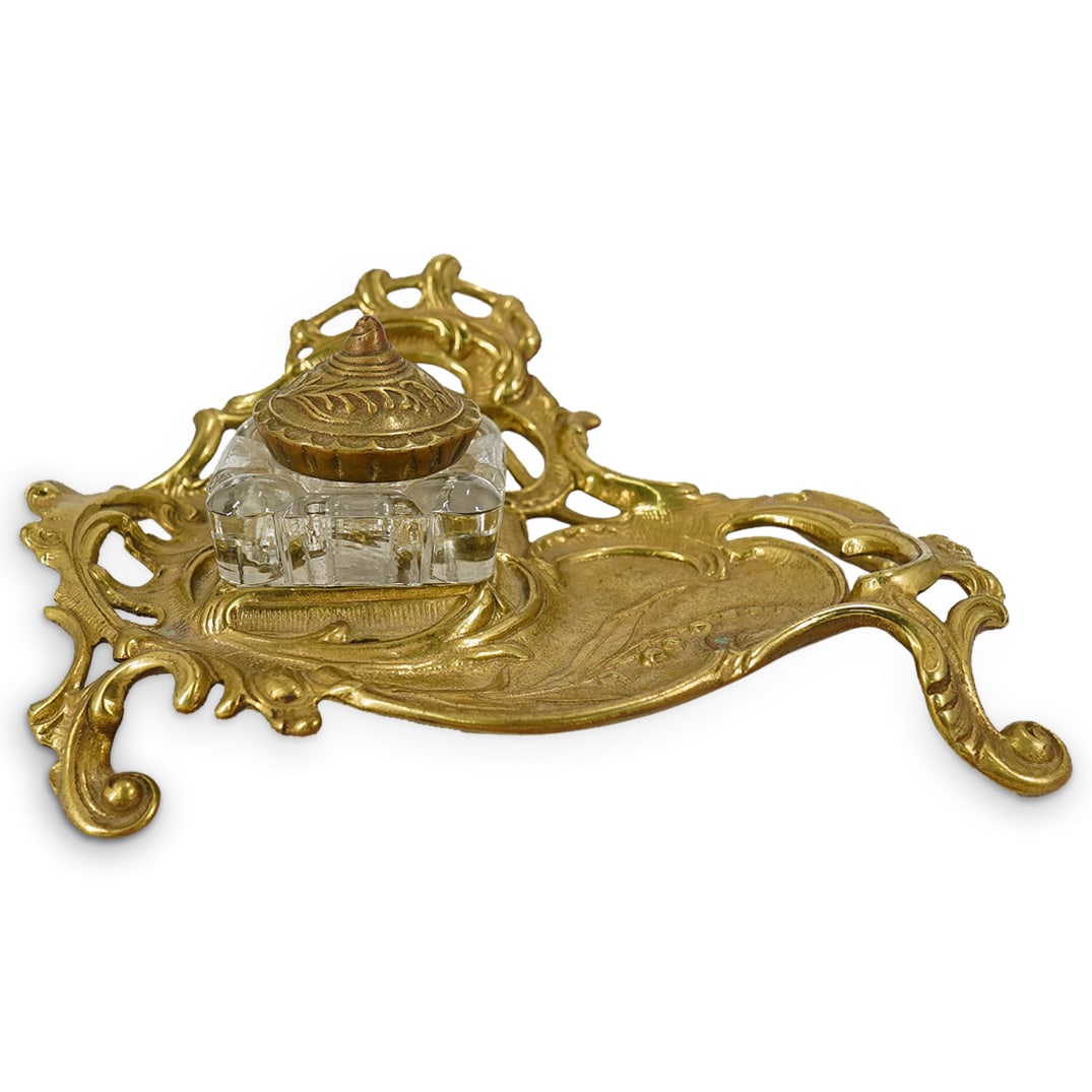 Art Nouveau Brass Inkwell: DESCRIPTION: An antique French Art Nouveau brass inkwell with ornate open-work and floral reliefs, fitted with original glass blown lidded inkwell, marked: 'V&M' underside of brass marked: 'V&M, 7-11'