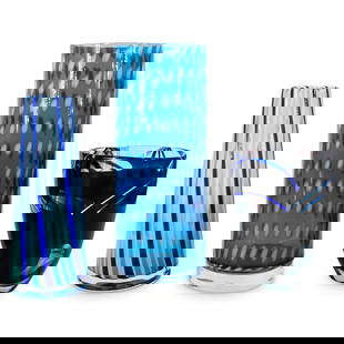 (3 Pc) Kosta Boda Glass Vases: DESCRIPTION: A group of three Kosta Boda glass vases feature the following: (1) Ann Wahlstrom for Kosta Boda tall cylindrical vase, signed along the underside. H: 12.5" W: 5.25" (1) Ludvig Lofgren for